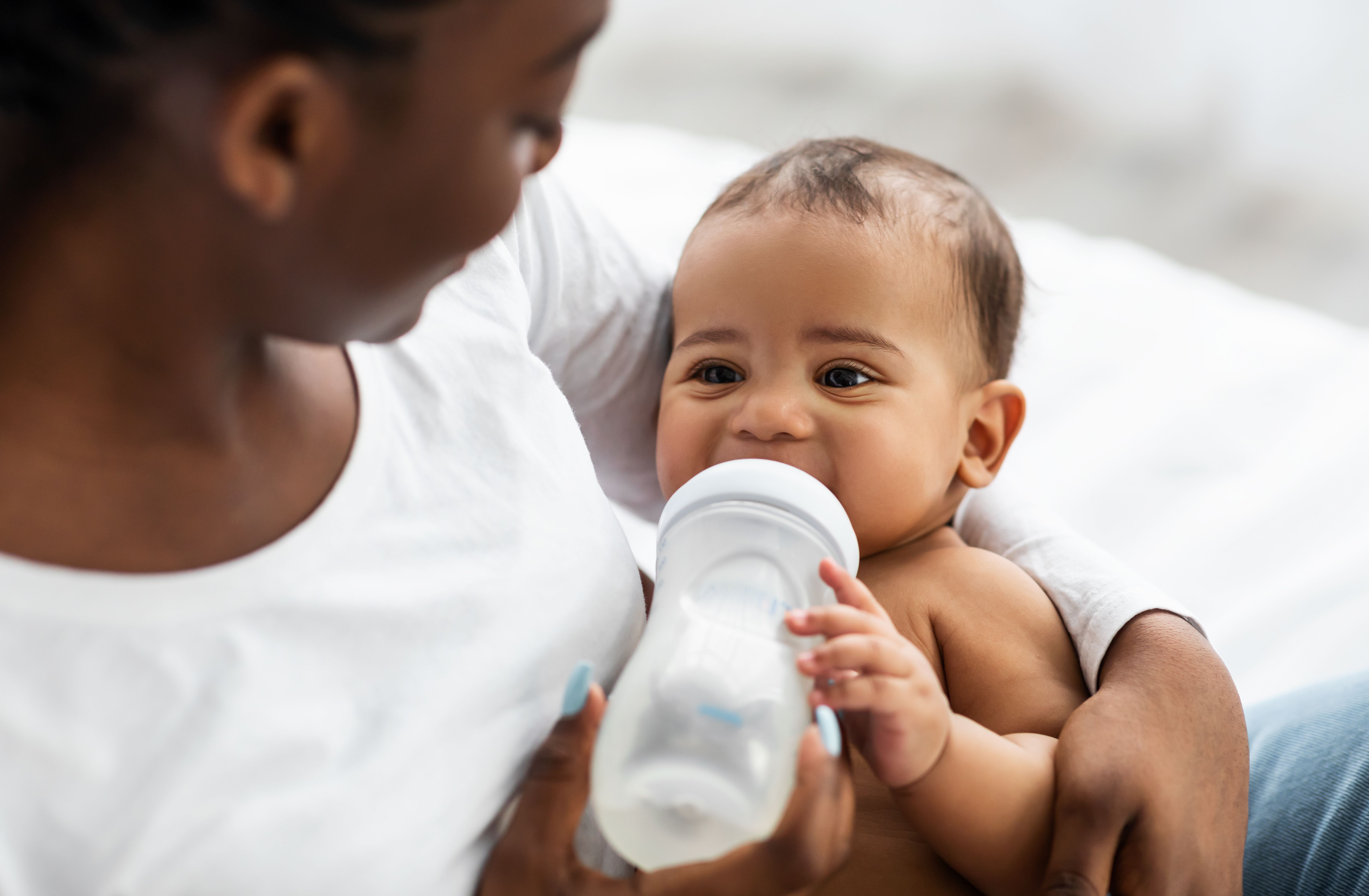 stock image of baby drinking formula | Credit: Adobe Stock