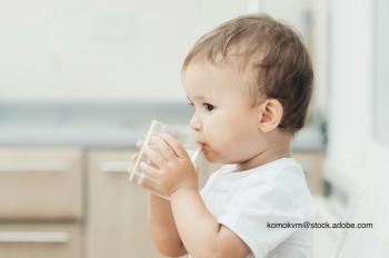 child drinking a glass of water
