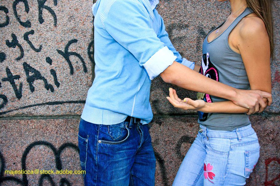 image of teen couple with the teen boy being rough with teen girl