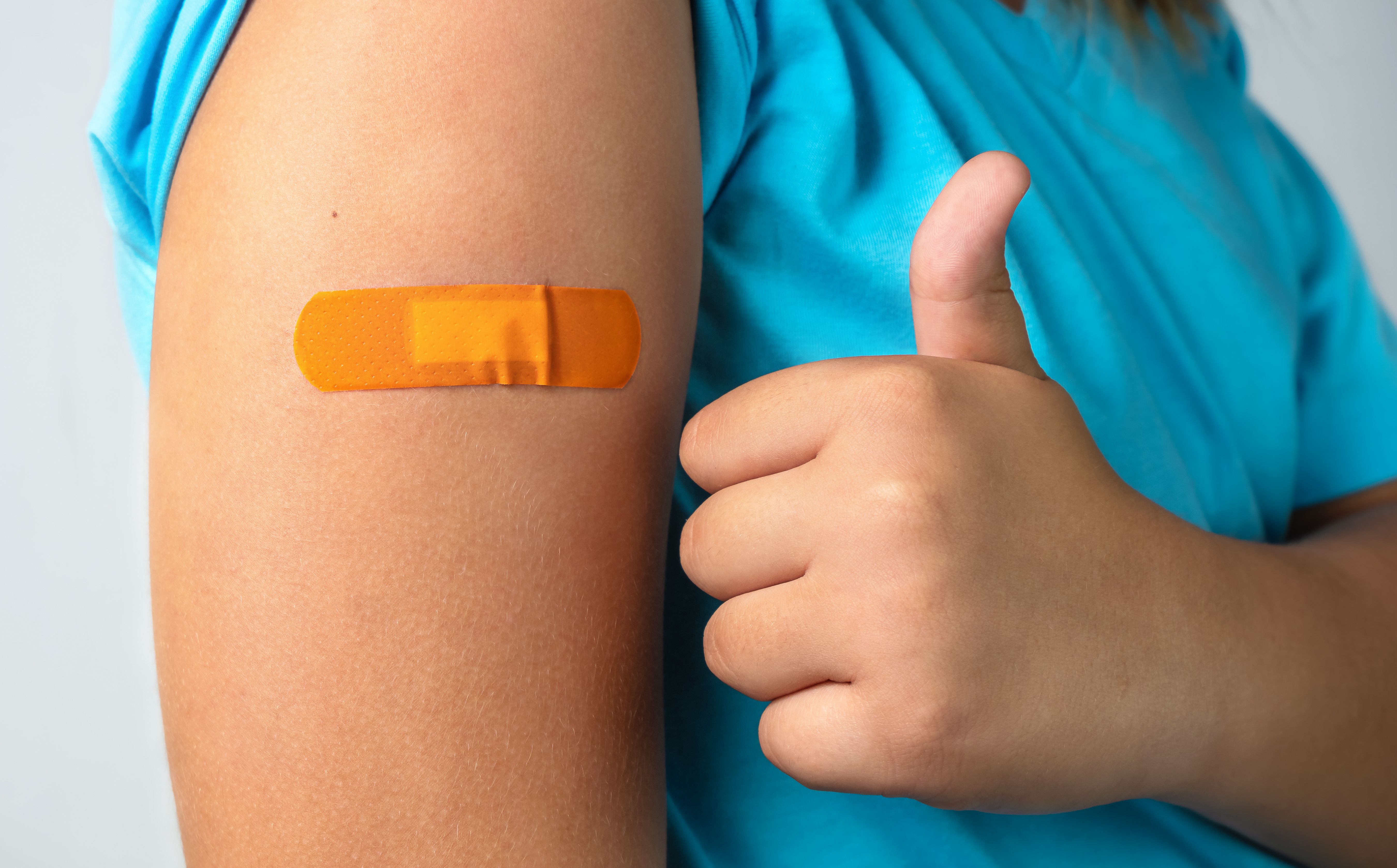 Child shows thumbs up after receiving vaccine | Image Credit: © Vasleriia Kuznetsova - © Vasleriia Kuznetsova - stock.adobe.com.