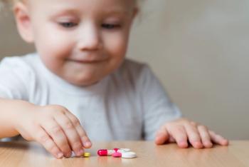 Child looking at pills | Image Credit: © Вячеслав Думчев - © Вячеслав Думчев - stock.adobe.com.