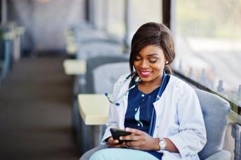 image of nurse reading on device