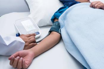 stock image of child having their blood pressure measured