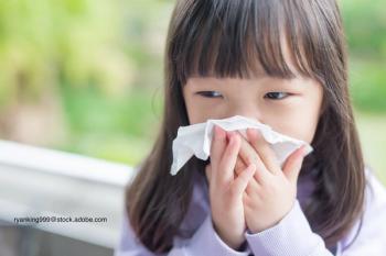 sneezing girl with facial tissue
