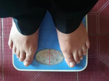 stock image of person on scale