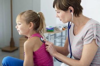 stock image of doctor checking a child's breathing
