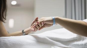 Image of a patient holding hands with a loved one.