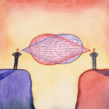 Two people speaking with each other in between two cliffs.