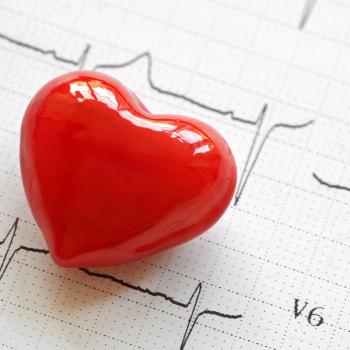 Photo of a cartoonish red heart-shaped object on an electrocardiogram printout