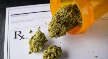 Marijuana coming out of a pill bottle and on to a prescription pad