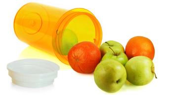 image of fruit spilling out of a pill bottle