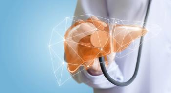 Doctor holding a stethoscope up to an image of a liver