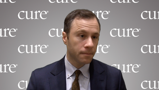 Dr. Michael Leapman in front of a gray, CURE-branded background