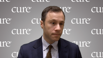 Dr. Michael Leapman in front of a gray, CURE-branded background