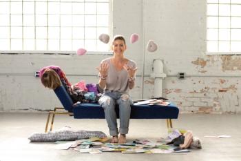 Branwyn Lee smiles at the camera and tosses up knitted breast implants