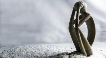 Image of a metal model holding its head in its hands.
