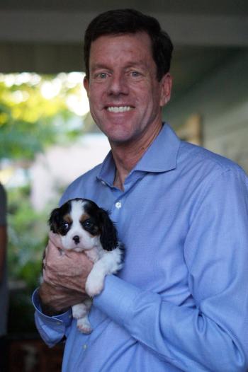 Bill C. Potts holding his small dog, Pippa | Photo credit: Sarah Potts 