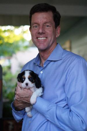 Bill C. Potts holding his small dog, Pippa | Photo credit: Sarah Potts