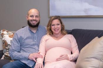Lung cancer survivor, Daniel Wilson, sitting next to his pregnant wife. Both are smiling at the camera. | Image credit: Robert Barilla