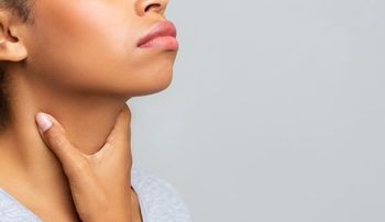 Picture of woman holding throat.
