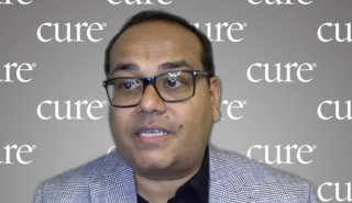 Image of a man with rectangular glasses and short dark hair.