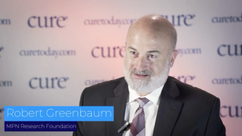 Image of bald man in suit.