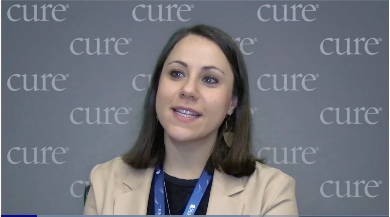 Image of a woman with brown shoulder-length hair, wearing a khaki colored blazer.