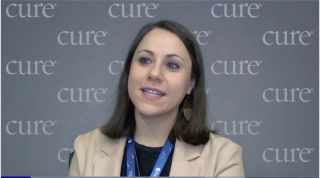 Image of a woman with brown shoulder-length hair, wearing a khaki colored blazer.