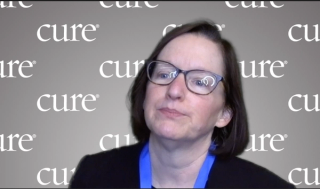 Image of a woman with short brown hair and glasses.