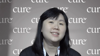 Image of woman with dark hair, smiling.