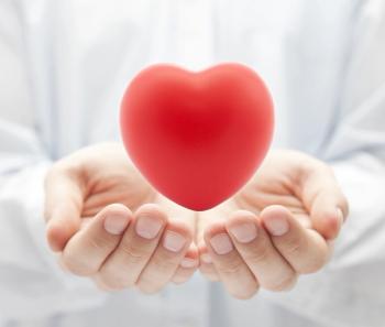 hands with a red heart above them
