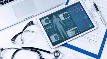 iPad with vital signs on it next to a stethescope