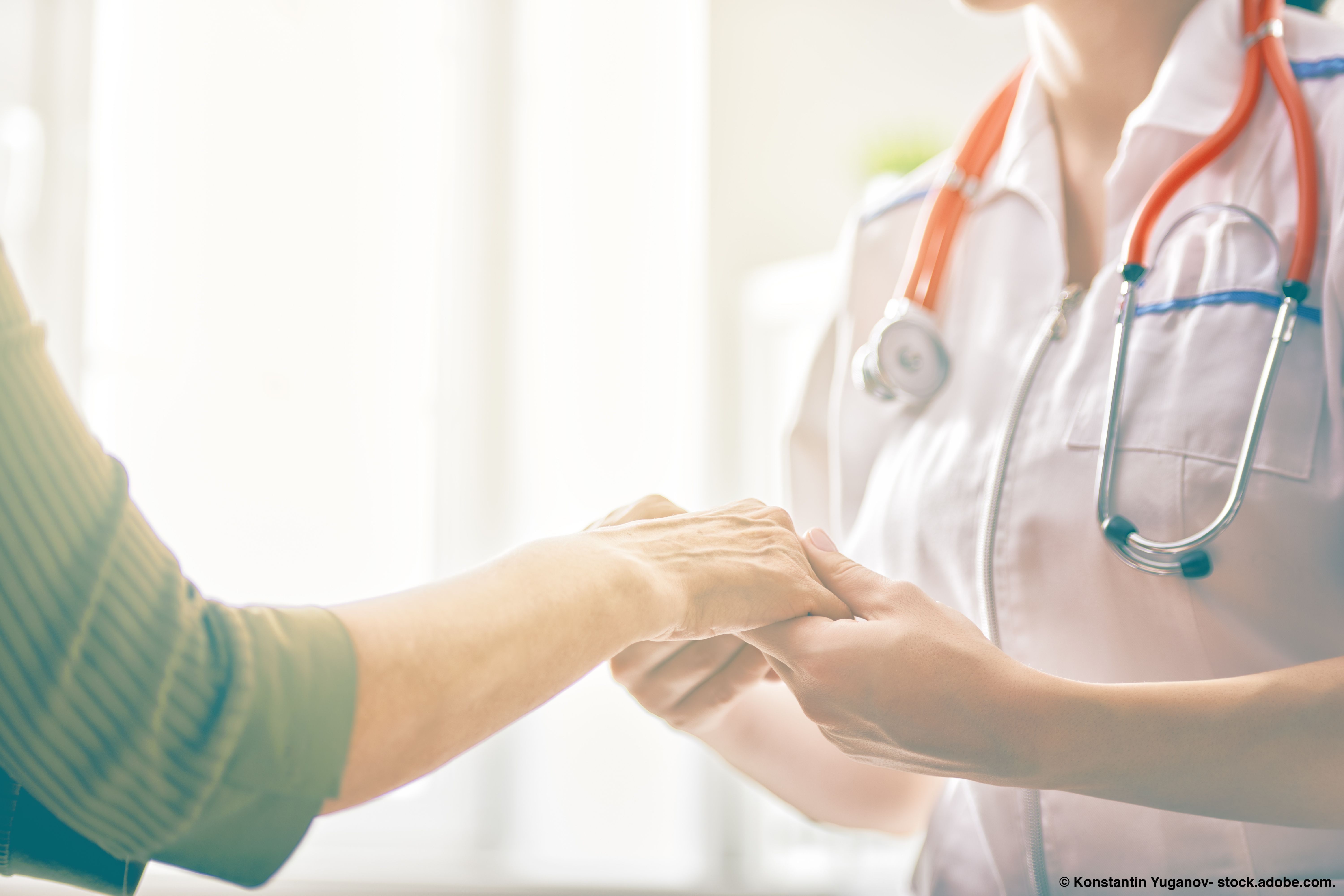 Image of a doctor holding a patient's hands.