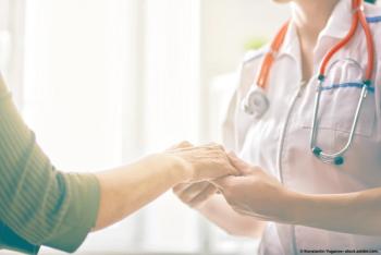 An image of a patient and doctor holding hands.