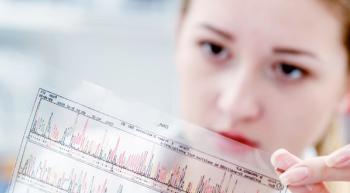 A scientist looks at a DNA panel