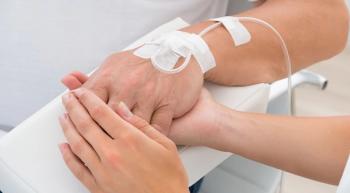oncology nurse holding patient's hand