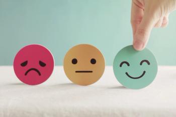 Image of three emotions, with a hand reaching for the smiley face.