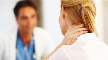 Image of woman holding neck.