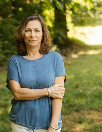 Ovarian cancer survivor, Kathy Ventre, stands outside, looking at the camera | Photo credit: Olivia Peltier
