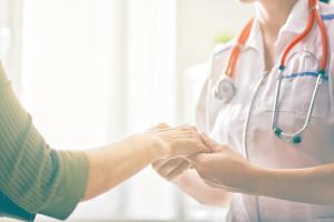 Image of a patient talking to a nurse. 