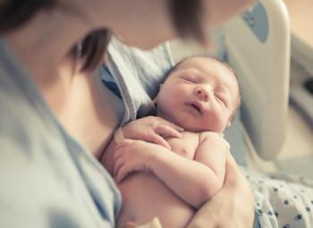 Picture of woman holding her baby in the hospital.