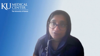 Image of a woman with glasses and dark hair.