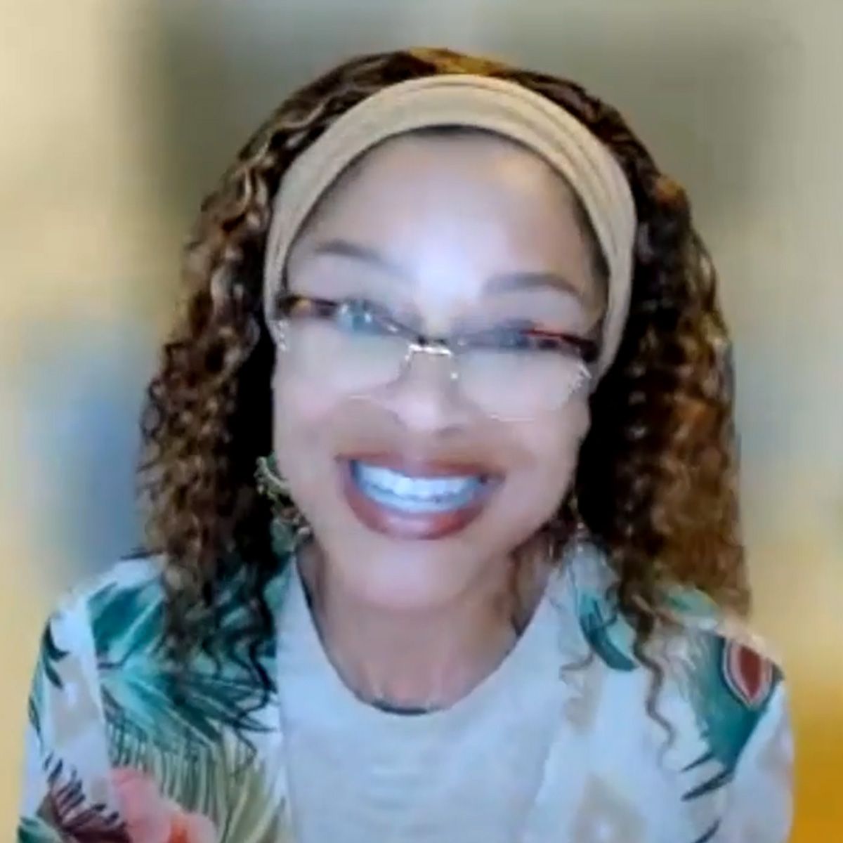 Image of a woman wearing a headband and glasses