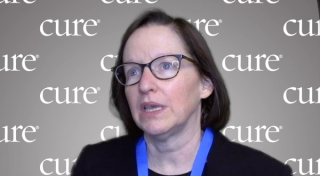 Image of a woman with short brown hair and glasses.