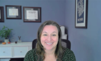 Image of a woman with brown hair smiling. 