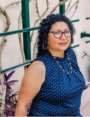 Endometrial cancer survivor, Stephenie Black-Grant is a black woman with curly hair and a polka dot shirt. She is looking at the camera | a Photo by Jessica Friend 