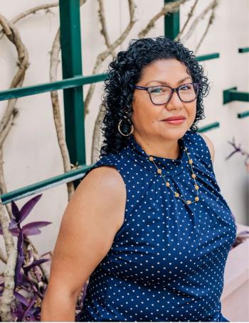 Endometrial cancer survivor, Stephenie Black-Grant is a black woman with curly hair and a polka dot shirt. She is looking at the camera | a Photo by Jessica Friend 
