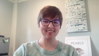 Image of a woman with short brown hair, wearing glasses.