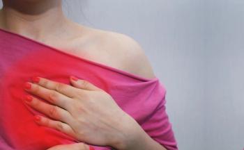 Image of woman holding her chest.