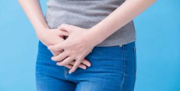 Image of woman holding her stomach.